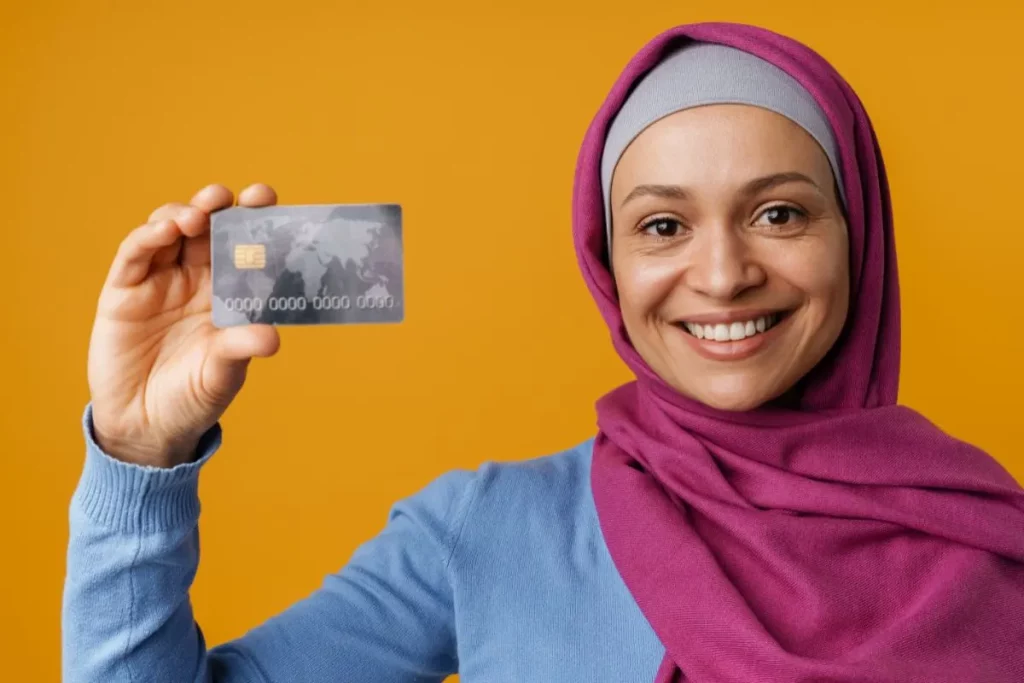 muslim woman holding a debit card